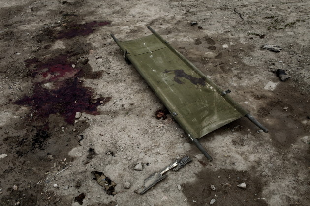 A stretcher and blood stain remain on the ground after an ISAF convoy consisting of Italian military vehicles was targeted in a car bomb attack in Kabul, Afghanistan, 2009. Six Italian soldiers and an estimated ten civilians were killed in a car bomb attack on the ISAF military convoy.