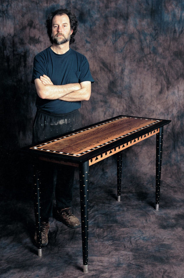 Greg Collins with one of his tables. Some of the timber species he uses for his coloured inlay work include lignum vitae, medicine wood, pink ivorywood, cocobolo, Indian rosewood, kingwood, black palm, ebony, purpleheart and tagua nut. Photo: Steven Blakeney