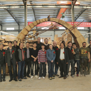 The collaborative team that worked on the 'Harmony between Man and Nature' project in Dongxiang, China. They are standing in front of the archway that was created by the international team, then worked on by the Chinese team.