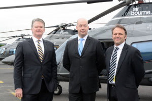Moorabbin Airport Chief Executive Paul Ferguson, Minister Gordon Rich-Phillips and AirMelbourne Director John Borg with three of the company's Agusta 109s. (Steve Hitchen)