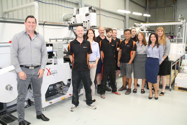 The Impact Labels team (MD Byron Hudghton on left) with the new OMET XFlex X6 press (supplied by Currie Group).