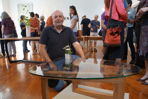 Jeff Freeman with his Coffee Bean coffee table in the foreground at the opening of Alumni, Feb 19, 2017.