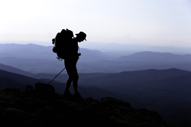 &copy; Male Backpacker on Mountain Peak.&copy; Christine Glade/Getty Images