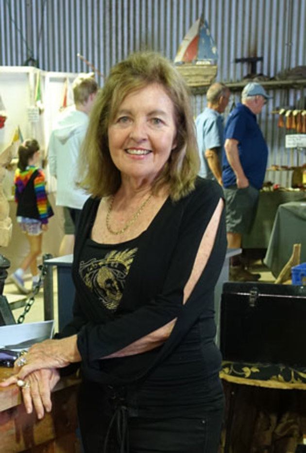 Maureen Powell on wood sculptor Donald Powell's stand. Don won first prize in the Wootha competition.