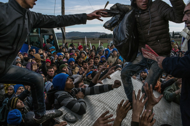 Documentary Series Winner. Idomeni, Greece, November 28, 2015. Barred refugees struggle for donations of water, blankets, diapers and a few clothes. &copy; Mauricio Lima.