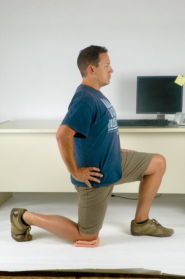 The last of the lower limb stretches reverses the effects of sitting with your hips in flexion all day. The importance of this muscle cannot be ignored&mdash;a tight, overactive hip flexor will draw your spine forwards and place stress on the lower back when riding, especially when driving big gears or seated climbing.
Kneel your right knee down on a folded towel. Have your left hip bent and foot on the floor. Draw forwards at the hip, keeping pelvis horizontal (buttock tucked under). 
You should feel stretch down the front of your hip and thigh. Hold it for 20 seconds and repeat twice on each side. Perform this one both before and after exercise.