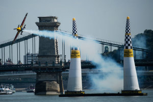 Local hero Peter Besenyei roars beneath the Chain Bridge and onto the track at the 2015 Budapest round of the Red Bull Air Race. (Joerg Mitter/Content Pool)