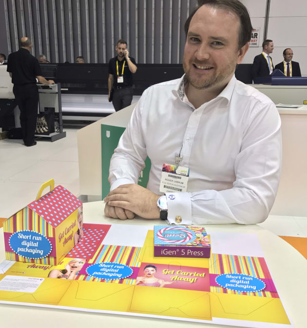 Fuji Xerox Australia's Roger Labrum shows off products printed on the iGen 5 at PacPrint 2017.