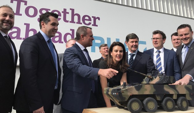 RUAG and BAE executives and Goldstein MP Tim Wilson look at a AMV35 model at RUAG's facility in Bayswater. Credit: BAE Systems Australia