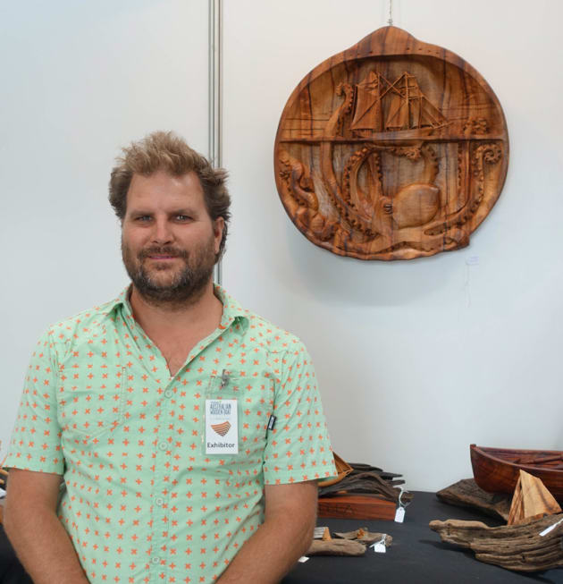 Radha Pedersen with his nautically themed woodcarving.