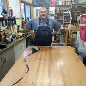 Ray Halpin with his eucalypt outdoor setting featuring inlaid motif of resin cast pebbles and stones.