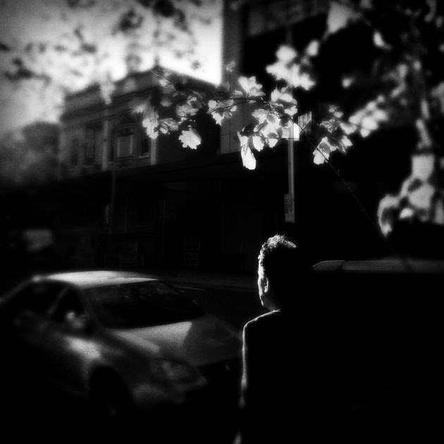 Rays of the sun engulf a pedestrian. North Sydney, Australia.