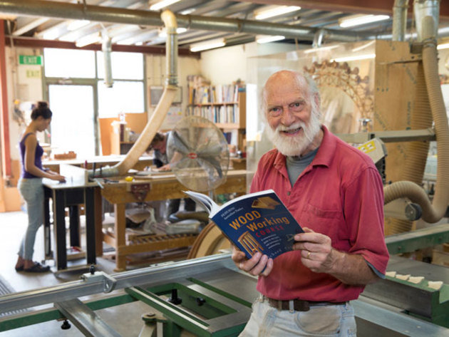Richard Crosland at his School of Fine Woodwork in Alexandria, Sydney with his recently reprinted book. Photo: Selena Simpson