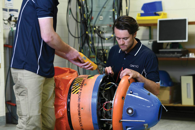Qinetiq technicians inspect one of the RAN's training mines. Credit: Qinetiq Australia