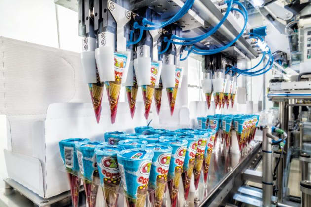 Waffles are carefully picked up using suction and transported.