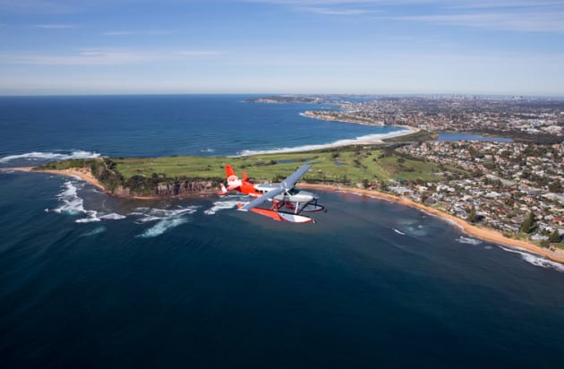 A Sydney Seaplanes Caravan amphibian over Northern Beach. (Sydney Seaplanes)