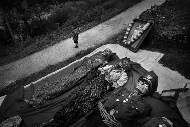 &copy; Alain Schroeder, Belgium. WINNER, TRAVEL PHOTOGRAPHER OF THE YEAR 2017. Tandung village near Pangala, Toraja, Sulawesi Island, Indonesia.  In the region of Pangala, the Ma' Nene, or cleaning of the corpses, ceremony takes place in August after the rice harvest. Coffins are removed from their burial sites and opened. The mummies are cleaned, dried in the sun and given a change of clothes.