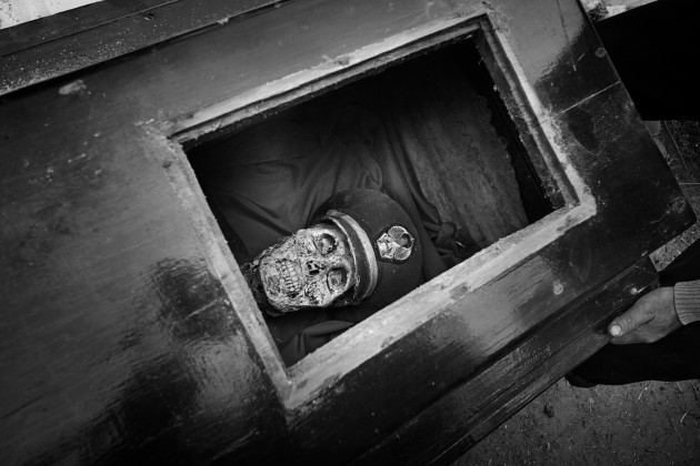 &copy; Alain Schroeder, Belgium. WINNER, TRAVEL PHOTOGRAPHER OF THE YEAR 2017. Tandung village near Pangala, Toraja, Sulawesi Island, Indonesia.  Ma' Nene ceremony. Captain Lode Sarungu wearing his military uniform, seen through the small window of his coffin.