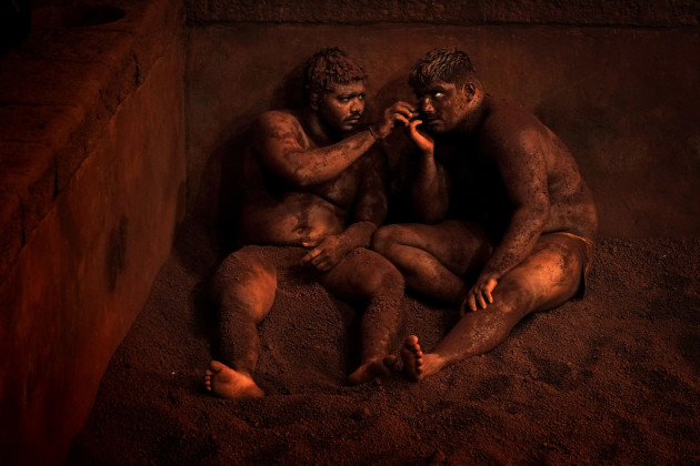 &copy; Alain Schroeder, Belgium. WINNER, TRAVEL PHOTOGRAPHER OF THE YEAR 2017. Kolhapur, Maharashtra State, India. At the end of a workout, wrestlers rest against the walls of the arena. This relaxation ceremony is completed with massages to soothe tired muscles and demonstrate mutual respect.