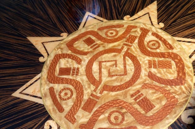 Detail of the marquetry work on Gavin Harrington's award winning Unity table in Macassar ebony with solid cherry edging. Gavin based the design on an Aztec Mayan symbol.