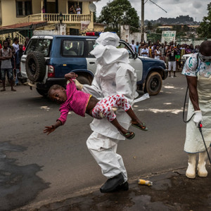 Esther Doryen, aged five, is carried to an ambulance in Monrovia. She died a week later. One image from the Australian photojournalist's portfolio. Daniel Berehulak/The New York Times.