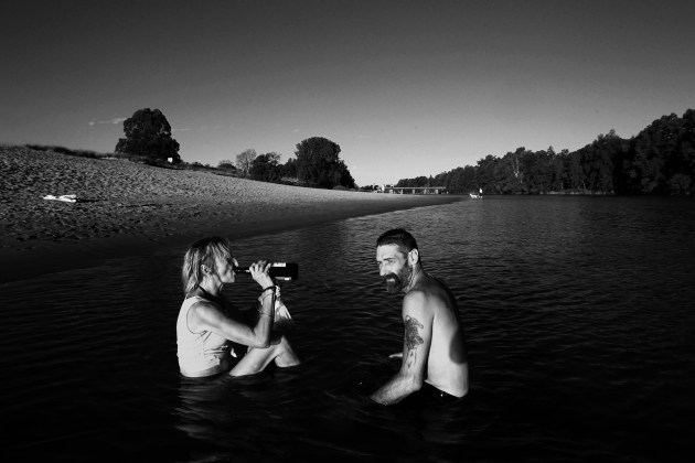 &copy; Dean Sewell/Oculi. Preteena and Dave enjoy an afternoon drink together during their bath hour in the Hawkesbury River. Preteena has endured a life of breadline poverty, sexual and domestic violence, substance addiction, schizophrenia, and cancer. Dave fell out of full-time employment, lost his home and family, and has struggled with substance addiction.