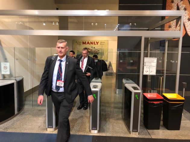 AFP officers leaving the ABC in Sydney after June's raid. (@thelyonsden).