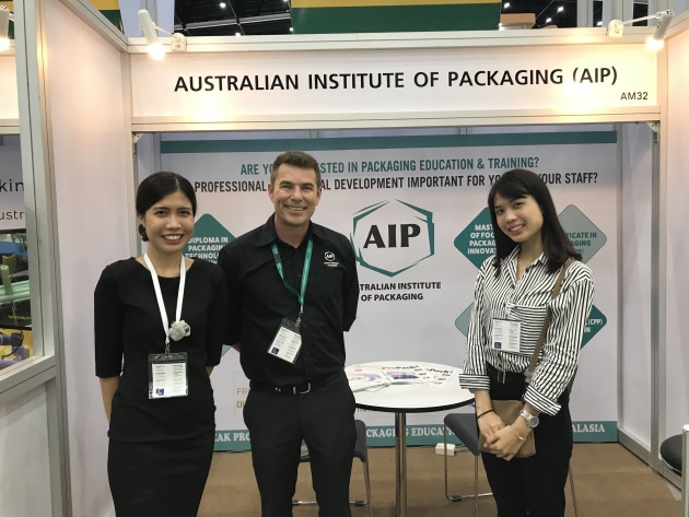 Mark Kelton  (centre) fields enquiries on the AIP stand.