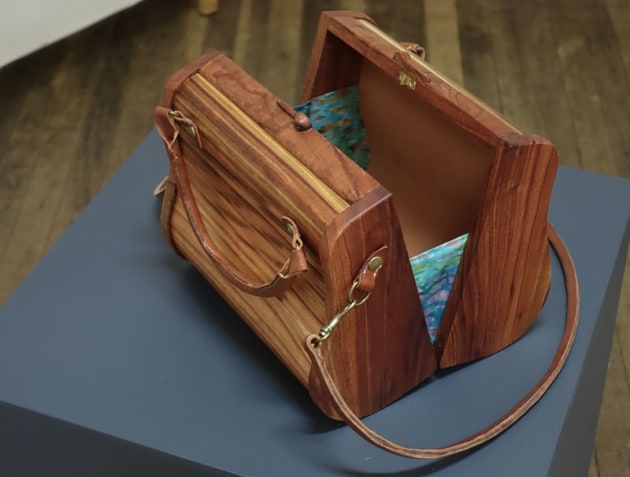 Allison Woods, The Pomona Handbag, camphor laurel, Australian red cedar, leather. The design is based on the shape of a pear, a very feminine and pleasing shape. The name was influenced by Greek, Roman and Italian mythologies where the goddess Pomona, watched over and protected trees and cared for their cultivation and the pear was also an influential item in these mythologies. 
It also reflects the name of an area on the Sunshine Coast.
This handbag gives the elegant woman not only an eye catching fashion statement, but also a unique functional piece to hold personal items and it will complement any outfit for any occasion.