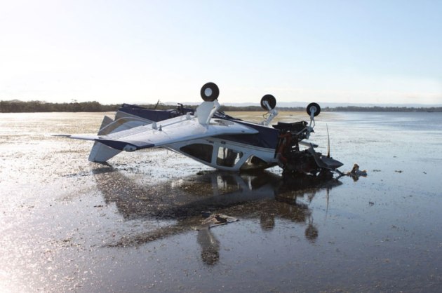 WMM inverted on the mud flat at low tide before recovery. (ATSB)