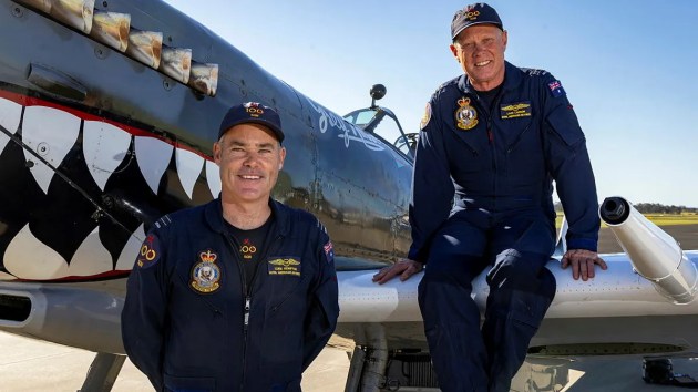 FLTLTs Luke Kempton, left, and Lars Larson with a Spitfire Mk VIII on the flight line at Temora Aviation Museum, NSW. (LACW Nell Bradbury)