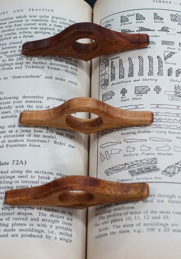Bevan Blackshaw, The Book Bird (Tiny Treasures), Vic ash, camphor laurel. "My Book Birds make one handed reading easy. The pointed part engages with the spine of the book and the wings hold the pages open. The hole can be sized to fit most thumbs. I generally make these in four sizes so they fit a wide range of thumbs. Best fit is up to the first knuckle of the thumb. They came about as a way to use a regular piece of workshop scrap and small off cuts from other work thus creating a product from potential landfill."