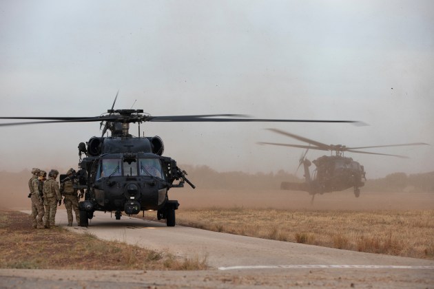 Soldiers from 2nd Commando Regiment prepare to fast-rope out of US Army MH-60 Black Hawk helicopters at RAAF Base Tindal. (Defence)