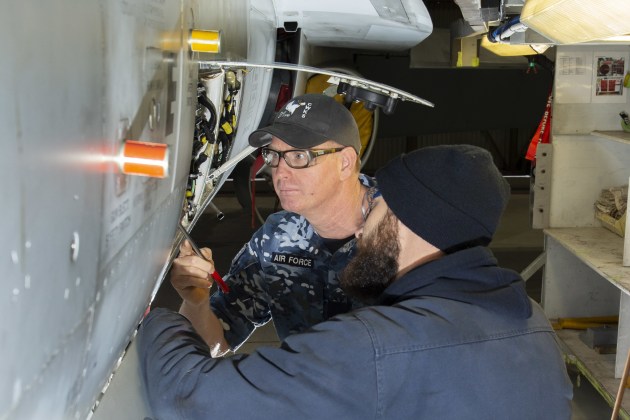 Sergeant Josh Keith from No. 81 Wing Combined Workshops and Samuel Bussing from Boeing Defence Australia conduct a final inspection on an F/A-18 Classic Hornet.
Defence