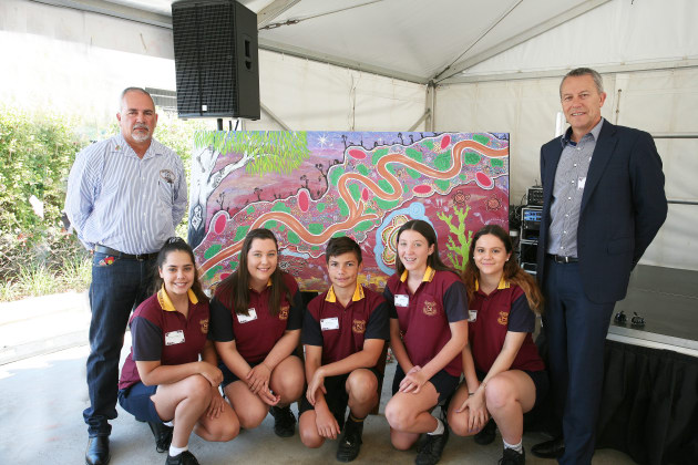 Broadspectrum Wellsite Operator and local Indigenous artist, Anthony Turnbull; students from Chinchilla State High School, Madison McConville, Sheila Stober, Blade Neslon, Cobi Zerbst, and Shivaree Herbert; Broadspectrum Managing Director and Chief Executive Officer, Nick Miller. Credit: Broadspectrum