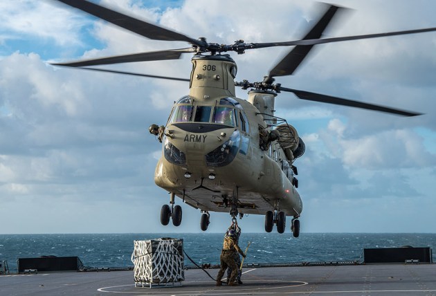An Australian Army CH-47 conducts a Class 4 VERTREP (Vertical Replenishment) on the flight deck of HMAS Choules during first of class flight trials in the Coral Sea. Credit: LEUT Grant Thaler/Defence