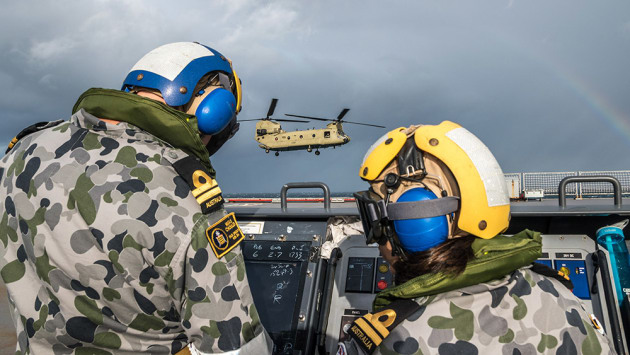 HMAS Choules Helicopter Control Officers, Lieutenant Andrew McGuigan and LEUT Melanie Soares conducting deck landing practice evolutions during CH-47 first of class flight trials in the Coral Sea. Credit:  LEUT Grant Thaler/Defence
