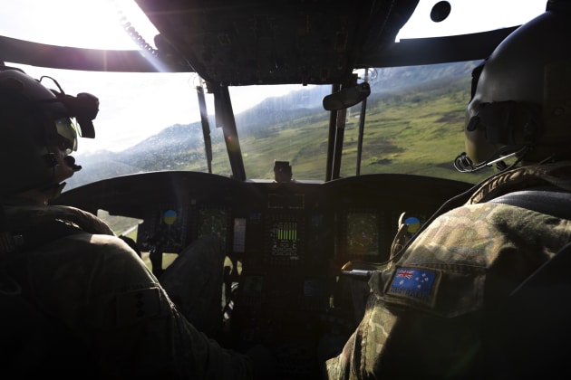 Army pilots Captain Frazer Watson (left) and Captain Steven Deyes fly a CH-47F Chinook helicopter towards Moro Airport.
Defence