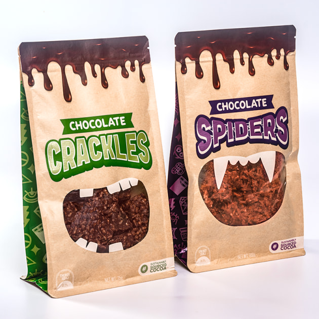 First iteration of the biodegradable packaging, featuring a window and die-cut detail, shown with Chocolate Crackles and Chocolate Spiders.