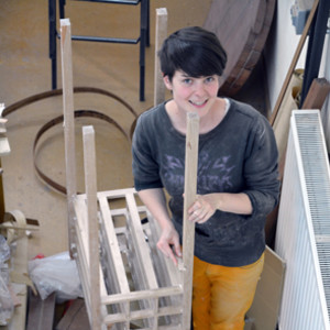 Claire Morgan, ANU SOA Furniture Workshop graduate adds the finishing touches to a piece.