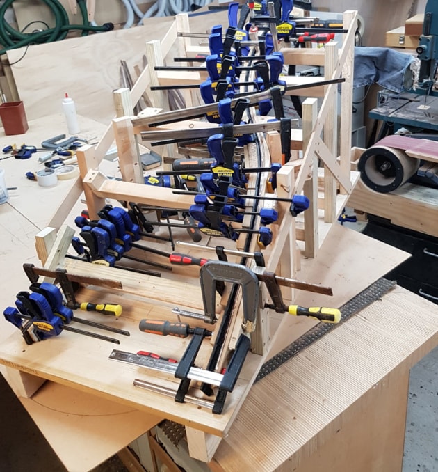 What a complex glue-up! Clamping the rear arms frame in the mould.