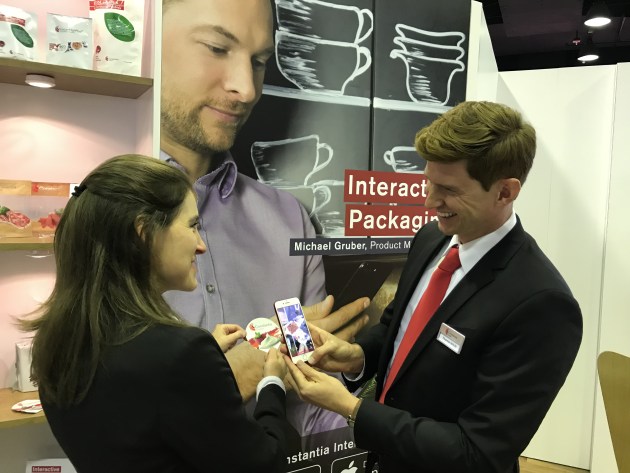 Constantia Flexibles interactive packaging solution is demonstrated by Thomas Schulz and colleague Carolina.