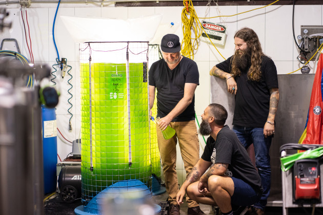 Young Henrys co-founders Richard Adamson and Oscar McMahon (above), and Young Henrys director Dan Hampton with the 400-litre algae bioreactor at the brewery.