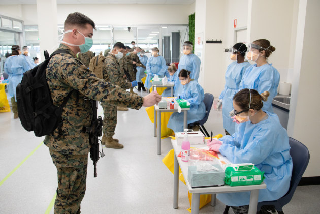 A combined medical team conduct pre-quarantine health screening for recently arrived US Marines.
Defence