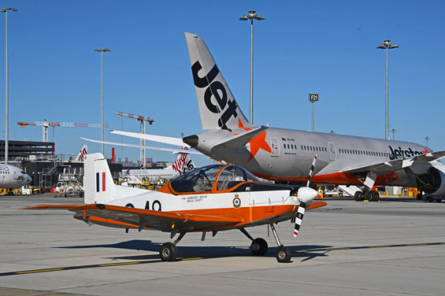 Wedgetail 3, CT4 049 "Mango" is dwarfed by a dormant Jetstar B787. (Steve Hitchen)