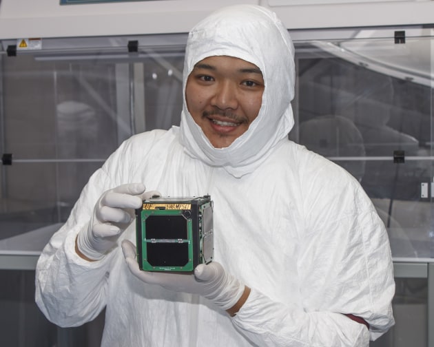 A student holding a CubeSat. Wikimedia