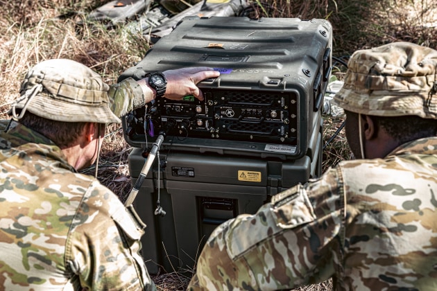 Army personnel using Currawong&rsquo;s Network Access Module (NAM) in a bush setting. 

Credit: Boeing Defence Australia
