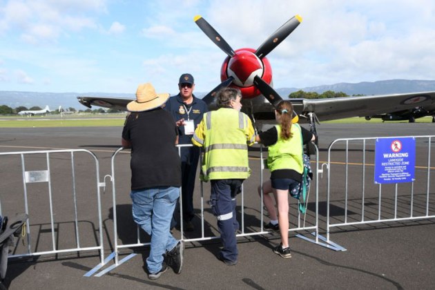 100 SQN pilot Steve Death entertains crowd members as the Sea Fury looks on from behind. (Steve Hitchen)