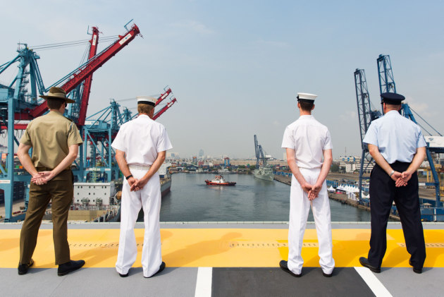 Members of HMAS Canberra's ships company and embarked forces line the flight deck during entry to Jakarta.
Defence