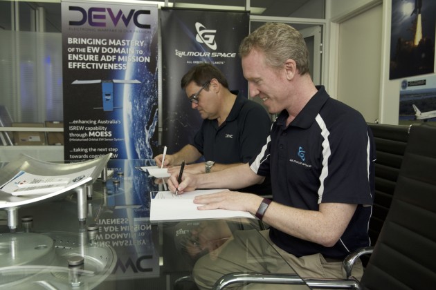 Ian Spencer, DEWC Systems CEO and Adam Gilmour, Gilmour Space Technologies CEO signing a Memorandum of Understanding. (Credit: DEWC Systems)